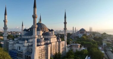 Istanbul, Turkey. Sultanahmet area with the Blue Mosque and the Hagia Sophia with a Golden Horn and Bosphorus bridge in the background at sunrise. Cinematic Aerial view. Hi quality 4K footage.