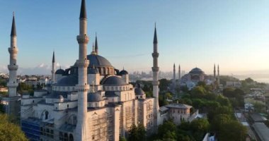 Istanbul, Turkey. Sultanahmet with the Blue Mosque and the Hagia Sophia with a Golden Horn on the background at sunrise. Cinematic Aerial view. Hi quality 4K footage.