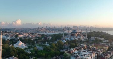 Istanbul, Turkey. Sultanahmet area with the Blue Mosque and the Hagia Sophia with a Golden Horn and Bosphorus bridge in the background at sunrise. Cinematic Aerial view. Hi quality 4K footage.