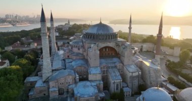Istanbul, Turkey. Sultanahmet with the Blue Mosque and the Hagia Sophia with a Golden Horn on the background at sunrise. Cinematic Aerial view. Hi quality 4K footage.