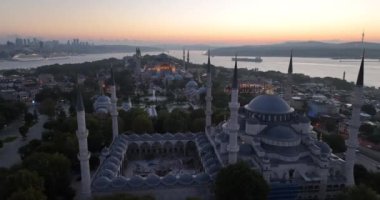 Istanbul, Turkey. Sultanahmet area with the Blue Mosque and the Hagia Sophia with a Golden Horn and Bosphorus bridge in the background at sunrise. Cinematic Aerial view. Hi quality 4K footage.