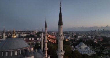 Istanbul, Turkey. Sultanahmet with the Blue Mosque and the Hagia Sophia with a Golden Horn on the background at sunrise. Cinematic Aerial view. Hi quality 4K footage.
