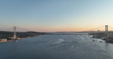 Istanbul Bosphorus Bridge and City Skyline in Background with Turkish Flag at Beautiful Sunset, Aerial slide orbiting and tracking shot. High quality cinematic 4k footage