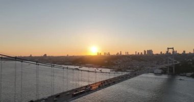 Istanbul Bosphorus Bridge and City Skyline in Background with Turkish Flag at Beautiful Sunset, Aerial slide orbiting and tracking shot. High quality cinematic 4k footage