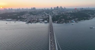 Istanbul Bosphorus Bridge and City Skyline in Background with Turkish Flag at Beautiful Sunset, Aerial slide orbiting and tracking shot. High quality cinematic 4k footage