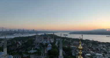 Istanbul, Turkey. Sultanahmet area with the Blue Mosque and the Hagia Sophia with a Golden Horn and Bosphorus bridge in the background at sunrise. Cinematic Aerial view. Hi quality 4K footage.