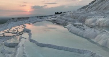 Pamukkale Travertines Cinematic Aerial Drone footage. Turkish famous white thermal bath with healthy clean water in a beautiful sunset. Aegean Region, Denizli Turkey