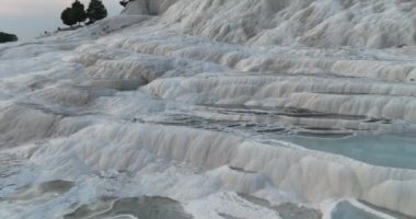 Pamukkale Travertines Cinematic Aerial Drone footage. Turkish famous white thermal bath with healthy clean water in a beautiful sunset. Aegean Region, Denizli Turkey