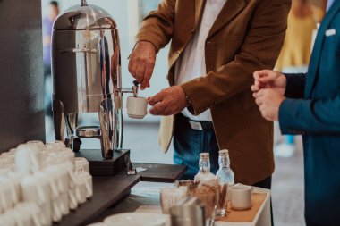 Close-up photo of businessmen serving themselves in a modern hotel during a dinner party. Selective focus . High quality photo