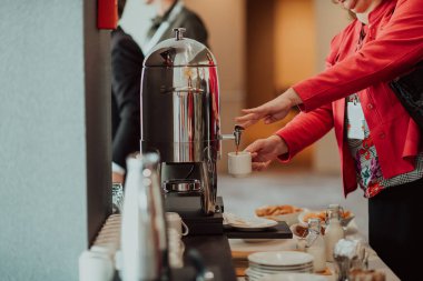 Close-up photo of businesswoman serving themselves in a modern hotel during a dinner party. Selective focus . High quality photo