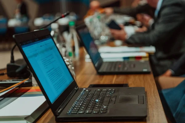 Photo of a laptop on a table in a modern seminar hall. Selective focus. High quality photo