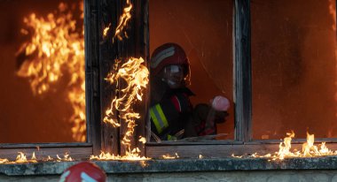 İtfaiyeci kahraman yangından sonra bebeğini yanan binadan dışarı taşıyor. İnsanları tehlikeli bir yerden kurtarmak. Takım çalışması Yüksek kalite fotoğraf