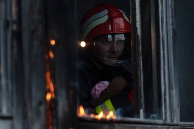 İtfaiyeci kahraman yangından sonra bebeğini yanan binadan dışarı taşıyor. İnsanları tehlikeli bir yerden kurtarmak. Takım çalışması Yüksek kalite fotoğraf