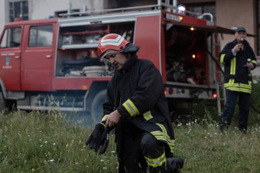 Depresyondaki yakışıklı bir itfaiyecinin portresi itfaiye aracının yanında. Yüksek kalite fotoğraf