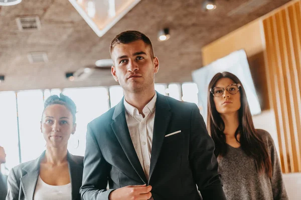 Portrait of a successful creative business team looking at the camera and smiling. Diverse businesspeople standing together at startup.