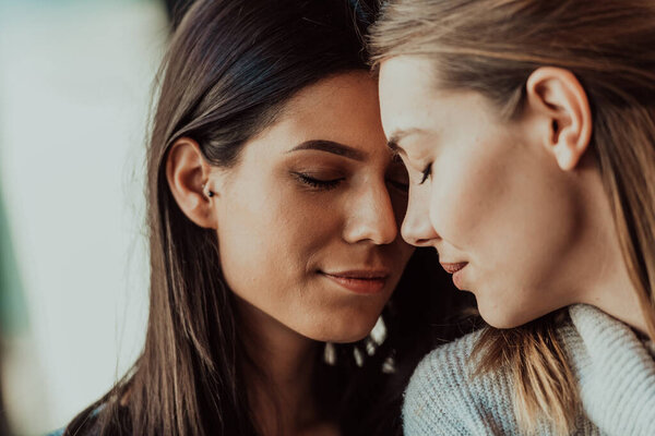 Diverse girls lesbian couple hugging. Close up portrait. Stylish cool generation z women dating in love enjoy romantic relationships. Lgbtq concept.