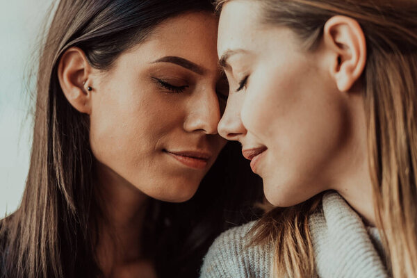 Diverse girls lesbian couple hugging. Close up portrait. Stylish cool generation z women dating in love enjoy romantic relationships. Lgbtq concept.