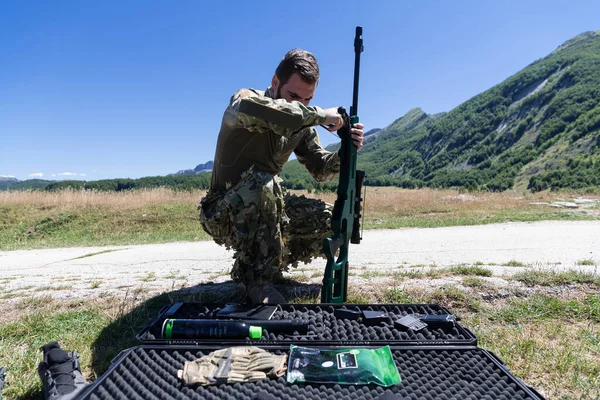 special operations soldiers team preparing tactical and communication gear for action battle. Long distance sniper team in checking gear for action.High quality photo