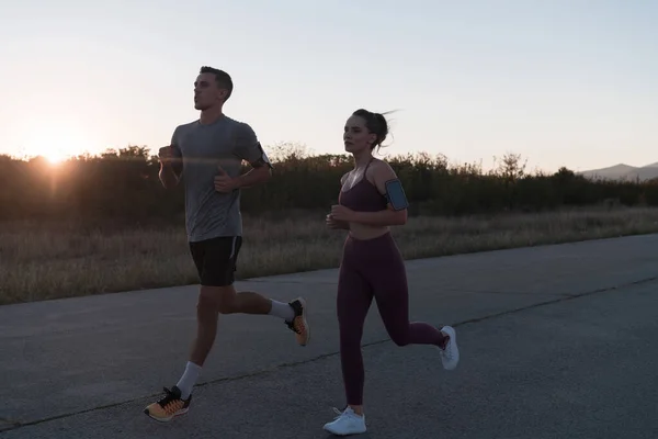 Healthy Young Couple Jogging City Streets Early Morning Beautiful Sunrise — Stock Photo, Image