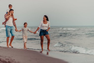 Family gatherings and socializing on the beach at sunset. The family walks along the sandy beach. Selective focus. High quality photo