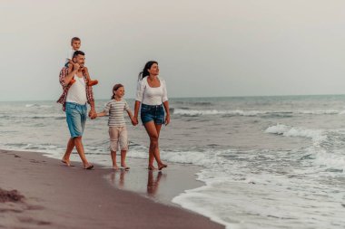 Family gatherings and socializing on the beach at sunset. The family walks along the sandy beach. Selective focus. High quality photo