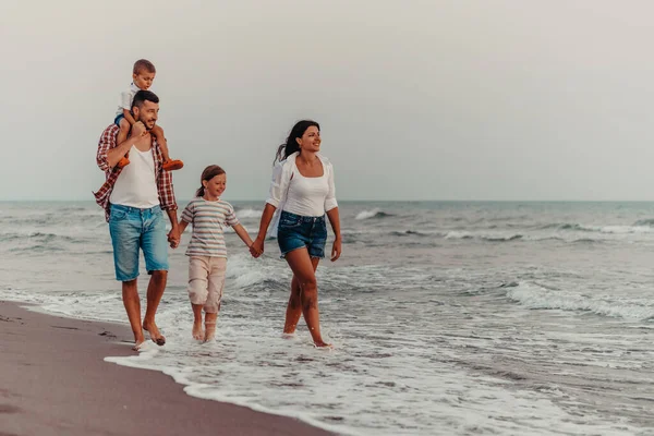 Family gatherings and socializing on the beach at sunset. The family walks along the sandy beach. Selective focus. High quality photo