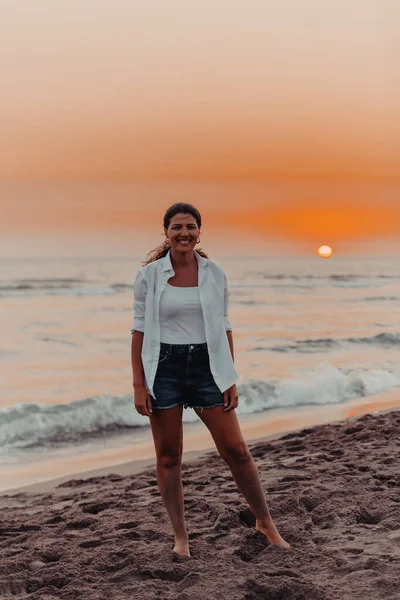 Happy Carefree Woman Enjoying Beautiful Sunset on the Beach. Selective focus . High quality photo