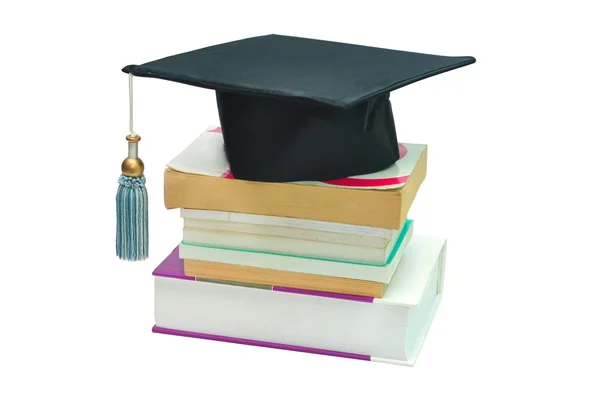 Graduation cap on top of a stack of books — Stock Photo, Image