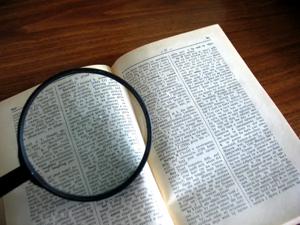 Book and magnifying glass — Stock Photo, Image