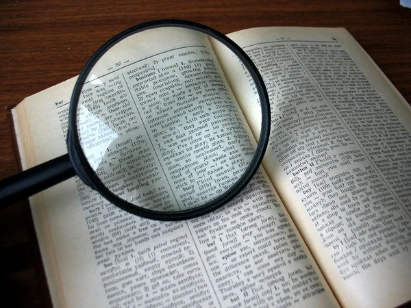 Book and magnifying glass — Stock Photo, Image