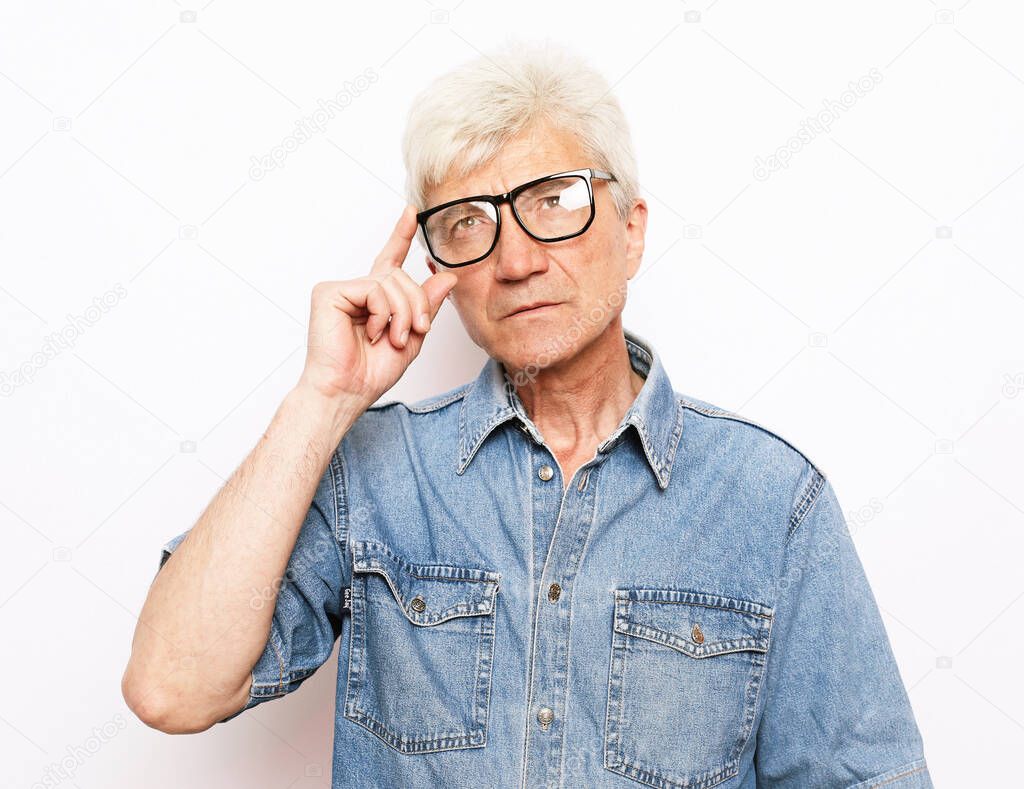 old age, problem and people concept: Portrait of thoughtful old man with eyeglasses over white background