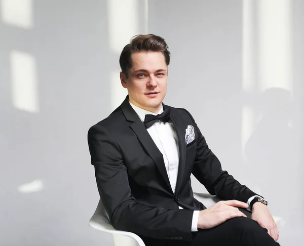 Young Fashionable Handsome Man Tuxedo Bow Tie Sitting Chair White — Stock Photo, Image