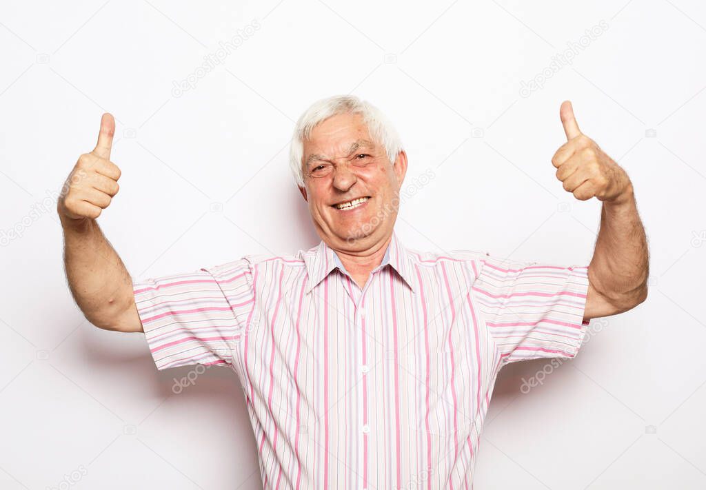 Photo of cheerful retired old male good mood show fingers thumbs-up advertisement isolated over white background