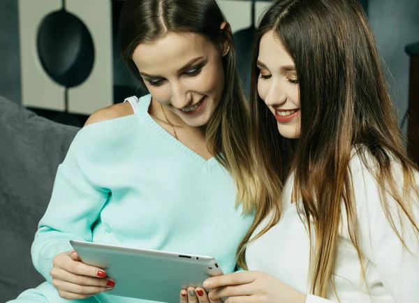 Дві молоді жінки вивчають щось на планшеті, онлайн-покупки, навчання . — стокове фото