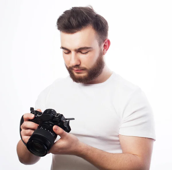 Lifestyle, fashion and people concept: young bearded man wearing white t-shirt with a digital camera — Stock Photo, Image