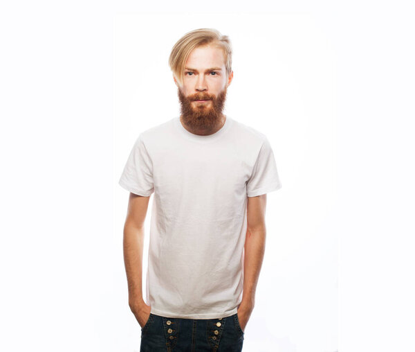 Lifestyle, fashion and people concept: Portrait of young handsome hipster man with red beard looking at camera over white background.
