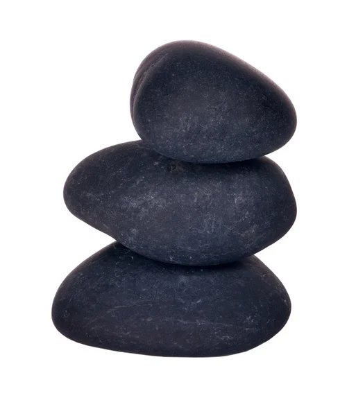 Три черных камня, изолированных на белом — стоковое фото
