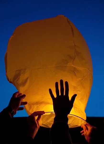 Yellow lantern in human hands — Stock Photo, Image