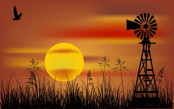 Moulin à vent dans l'herbe au coucher du soleil — Image vectorielle