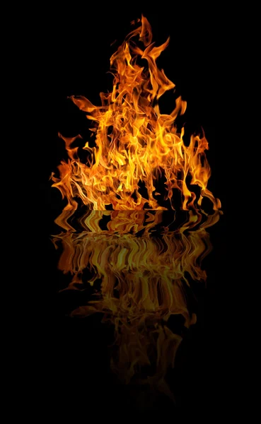 Bright yellow fire with reflection on black — Stock Photo, Image