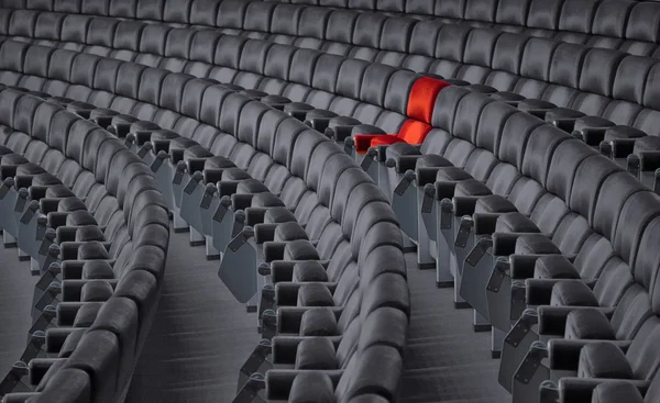 Red armchair in grey chair rows — Stock Photo, Image