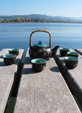 Chinese tea set on a wooden jetty
