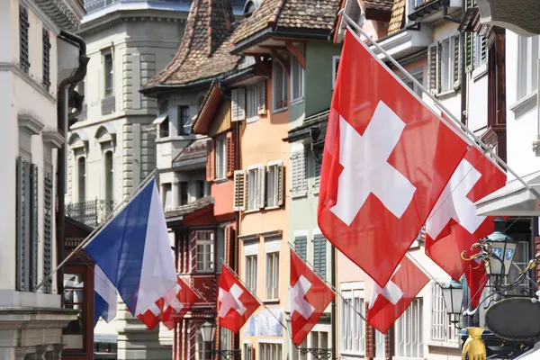 Gamla gatan i Zürich dekorerad med flaggor för schweiziskt nationella — Stockfoto