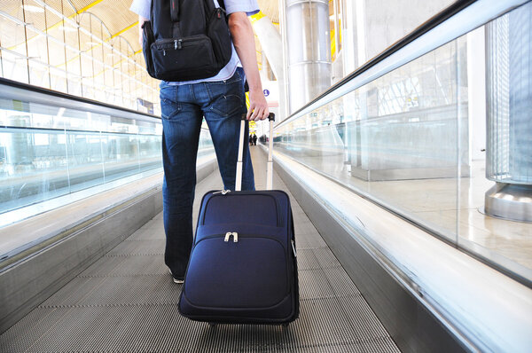 Traveler with a suitcase on the speedwalk