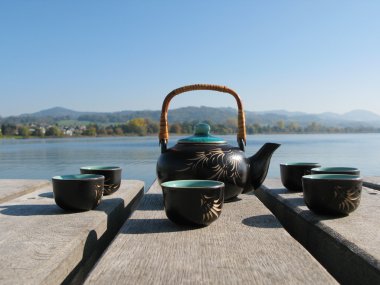 Chinese tea set on a wooden jetty