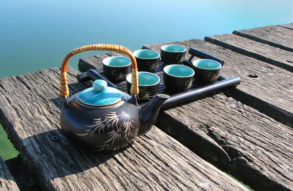 Chinese tea set on a wooden jetty — Stockfoto