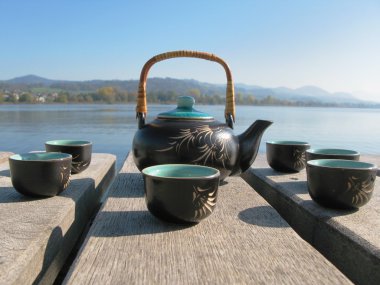 Chinese tea set on a wooden jetty
