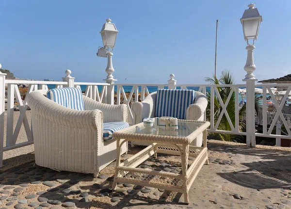 Two cane armchairs and a table on the terrace against Atlantic. — Stock Photo, Image