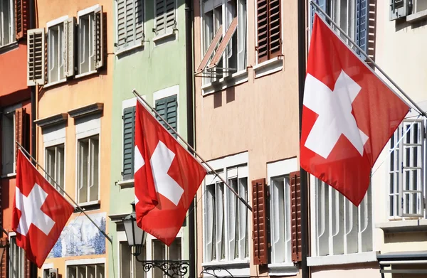 Old street in Zurich decorated with flags for the Swiss National — Stock Photo, Image