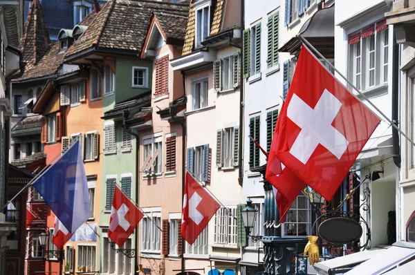 Old street in Zurich decorated with flags for the Swiss National — Stock Photo, Image